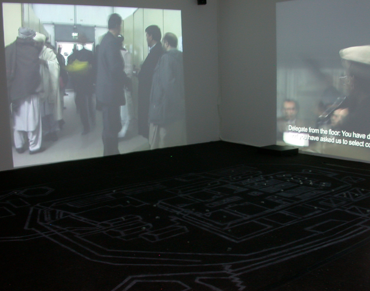 Kabul: Constitutions at Eyebeam in 2005: an interactive 3-channel video installation (rt 1:30:00) with 12' x 17' carpet stenciled with map, 3 microcontrollers, 3 Pioneer DVD players, wire, and up to 62 infrared proximity or pressure sensors